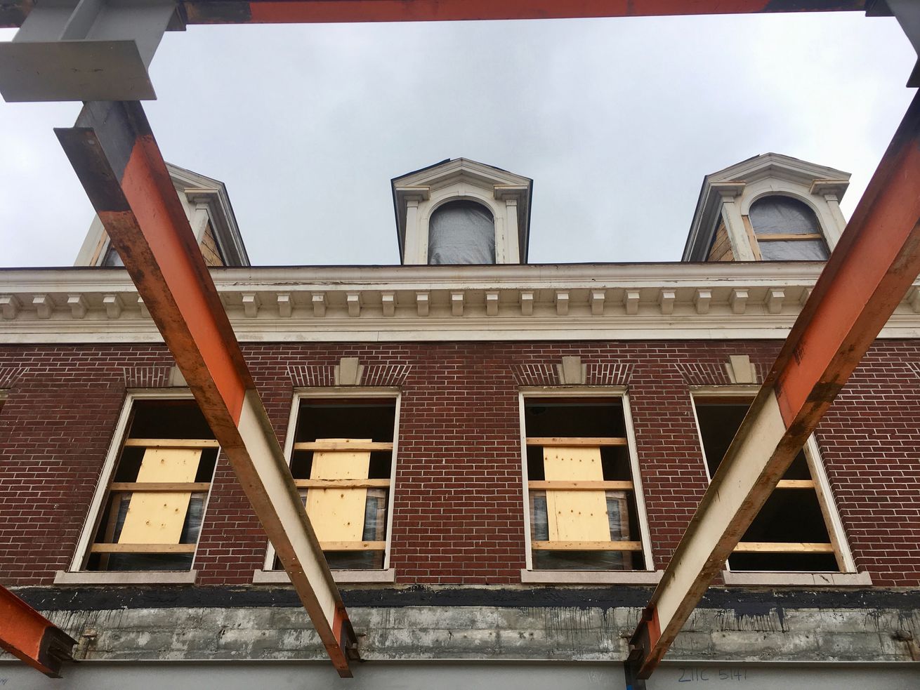 Steel beams fill in where a ceiling once stood between Building 9’s two main structures.